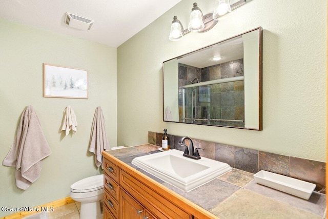 full bathroom with a shower stall, toilet, and vanity