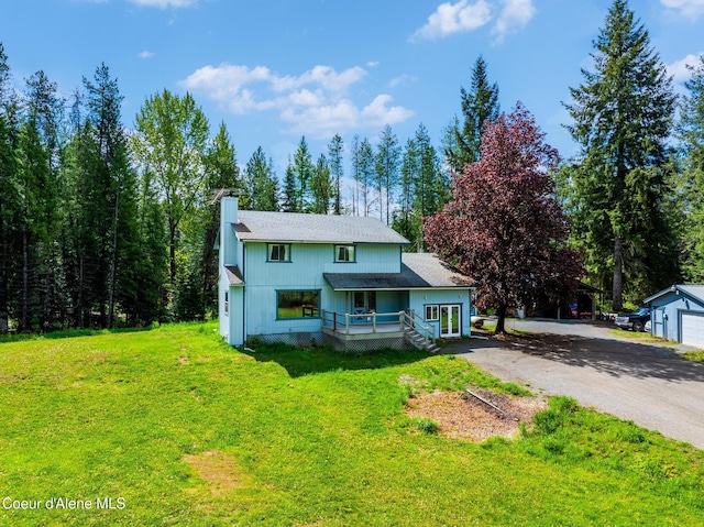 6699 Colburn Culver Rd, Sandpoint, ID 83864 - view of front of home featuring a chimney, dirt driveway, a front yard, and a shingled roof