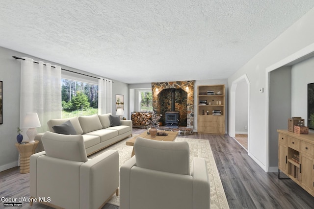 6699 Colburn Culver Rd, Sandpoint, ID 83864 - living room with wood finished floors, a textured ceiling, baseboards, a wood stove, and built in shelves