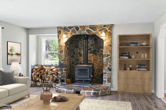 6699 Colburn Culver Rd, Sandpoint, ID 83864 - living area with a textured ceiling, wood finished floors, and a wood stove