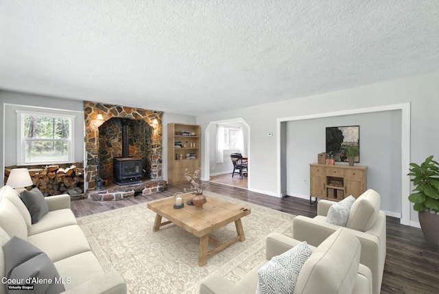 6699 Colburn Culver Rd, Sandpoint, ID 83864 - living room with a textured ceiling, healthy amount of natural light, dark wood finished floors, and a wood stove