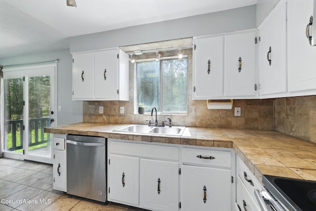 6699 Colburn Culver Rd, Sandpoint, ID 83864 - kitchen with stainless steel appliances, a sink, white cabinetry, tasteful backsplash, and healthy amount of natural light
