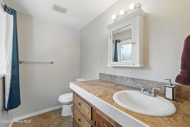 6699 Colburn Culver Rd, Sandpoint, ID 83864 - bathroom featuring vanity, toilet, tile patterned flooring, and baseboards