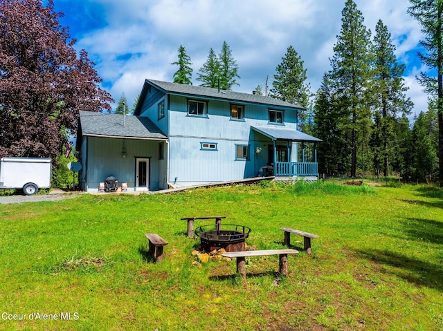 6699 Colburn Culver Rd, Sandpoint, ID 83864 - rear view of house with a fire pit and a yard