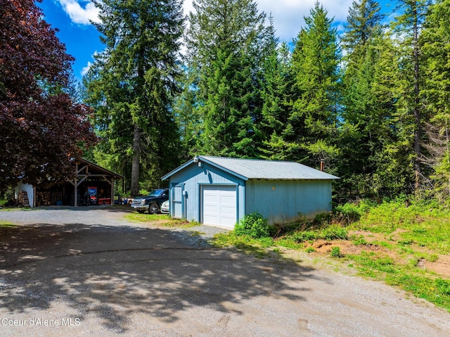 6699 Colburn Culver Rd, Sandpoint, ID 83864 - detached garage with driveway and a carport
