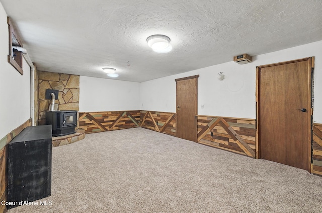 6699 Colburn Culver Rd, Sandpoint, ID 83864 - finished below grade area with carpet, a textured ceiling, and a wood stove