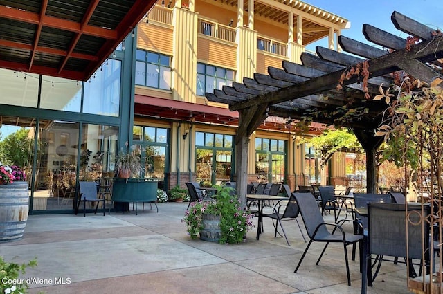 view of patio with outdoor dining area and a pergola