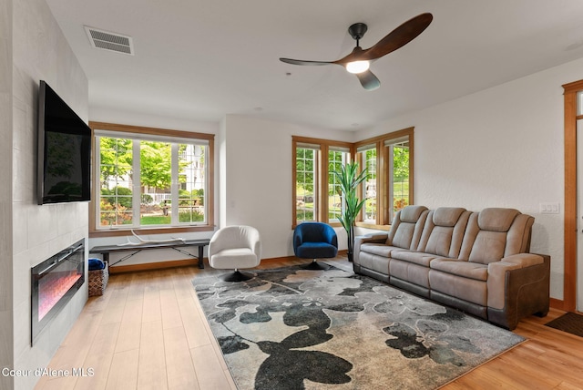 4461 W Greenchain Loop # 5, Coeur Dalene, ID 83814 - living area with ceiling fan, light wood finished floors, and a tiled fireplace