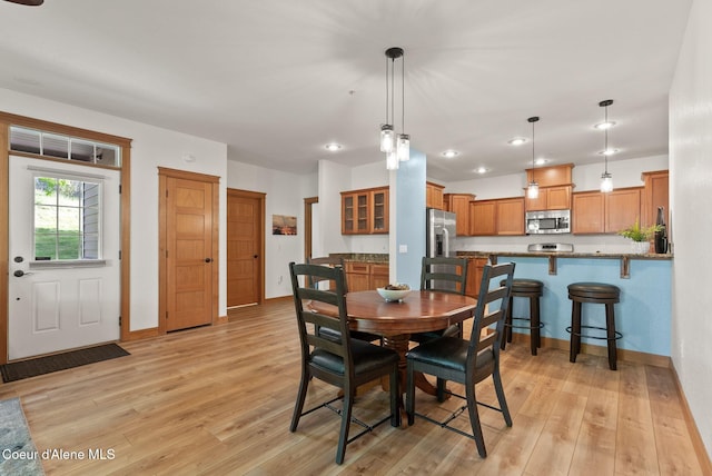 4461 W Greenchain Loop # 5, Coeur Dalene, ID 83814 - dining area with light wood finished floors, baseboards, and recessed lighting