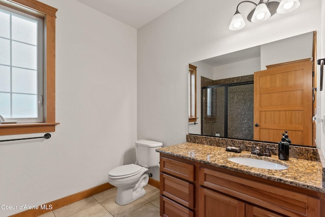 4461 W Greenchain Loop # 5, Coeur Dalene, ID 83814 - full bath featuring a shower stall, baseboards, toilet, tile patterned floors, and vanity