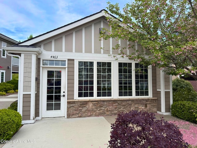 4461 W Greenchain Loop # 5, Coeur Dalene, ID 83814 - doorway to property with stone siding and a patio area
