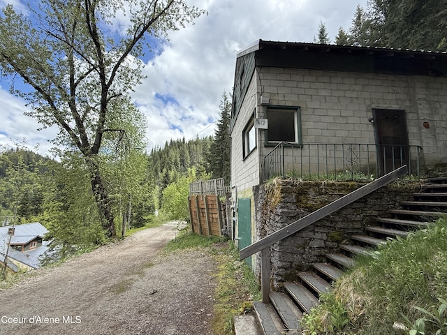 812 Silver St, Wallace, ID 83873 - view of side of home featuring stairway and a view of trees