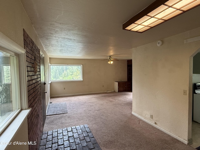 812 Silver St, Wallace, ID 83873 - carpeted spare room featuring ceiling fan, baseboards, and a textured wall