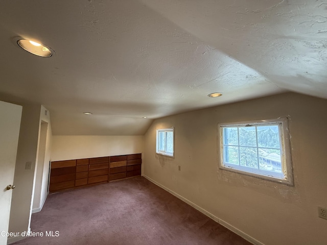 812 Silver St, Wallace, ID 83873 - additional living space with vaulted ceiling, carpet flooring, baseboards, and recessed lighting