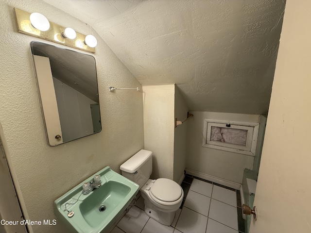 812 Silver St, Wallace, ID 83873 - bathroom with vaulted ceiling, a sink, toilet, tile patterned flooring, and a textured ceiling