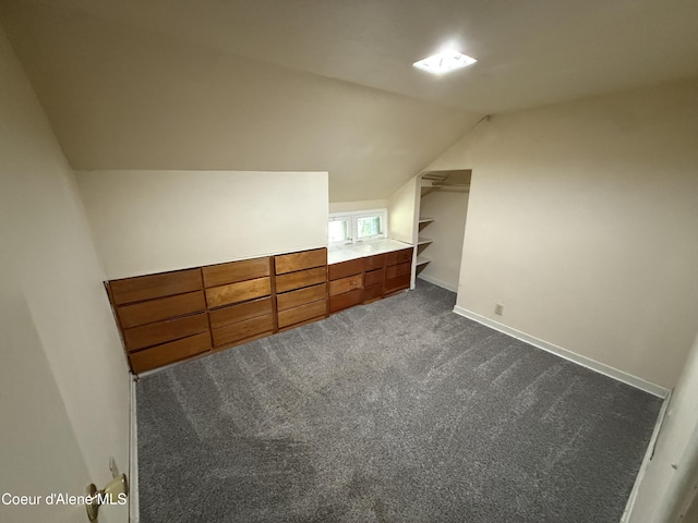 812 Silver St, Wallace, ID 83873 - additional living space with dark carpet, vaulted ceiling, and baseboards