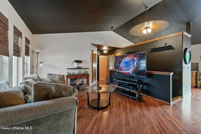 living area with wood finished floors, lofted ceiling, and a ceiling fan