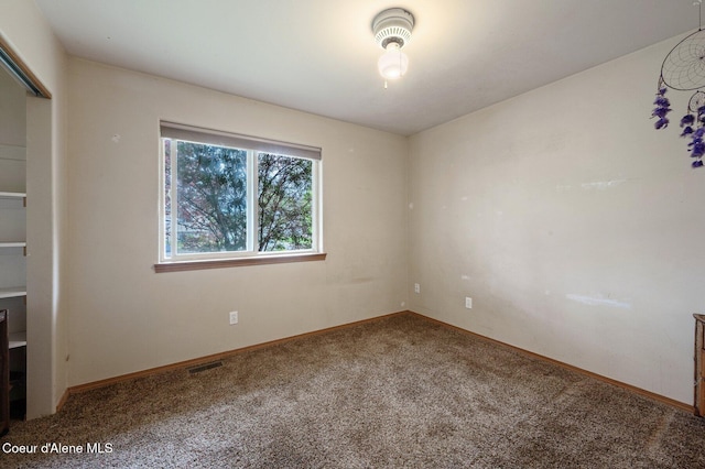 spare room with carpet flooring and baseboards