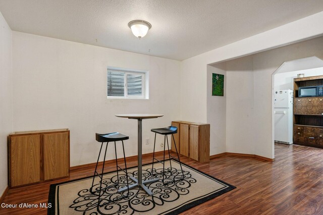 dining space featuring wood finished floors and baseboards