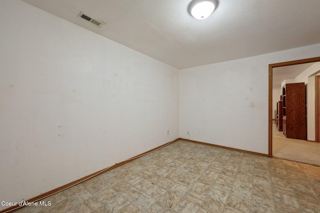 unfurnished room with baseboards and light floors