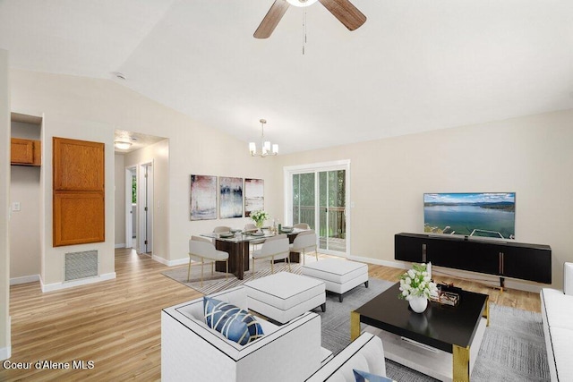 8694 N Clarkview Pl, Hayden Lake, ID 83835 - living area featuring vaulted ceiling, baseboards, light wood-style floors, a chandelier, and a ceiling fan