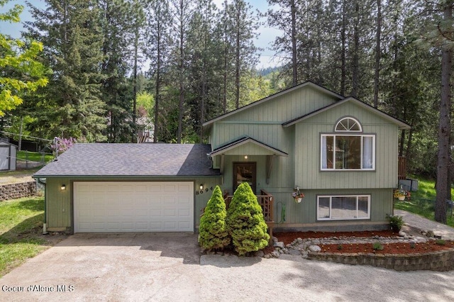 8694 N Clarkview Pl, Hayden Lake, ID 83835 - view of front of home featuring concrete driveway, a garage, and roof with shingles