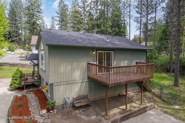 8694 N Clarkview Pl, Hayden Lake, ID 83835 - rear view of property featuring a shingled roof, a deck, fence, and stairs