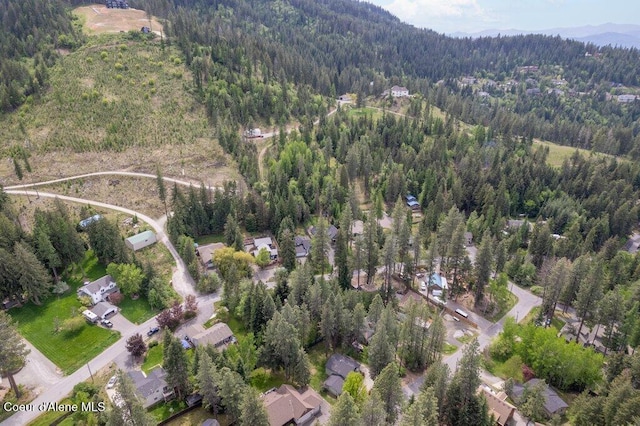 8694 N Clarkview Pl, Hayden Lake, ID 83835 - aerial view of property and surrounding area with a heavily wooded area and a mountain backdrop