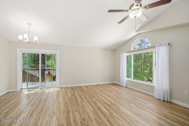 8694 N Clarkview Pl, Hayden Lake, ID 83835 - unfurnished living room featuring a chandelier, plenty of natural light, light wood finished floors, and lofted ceiling
