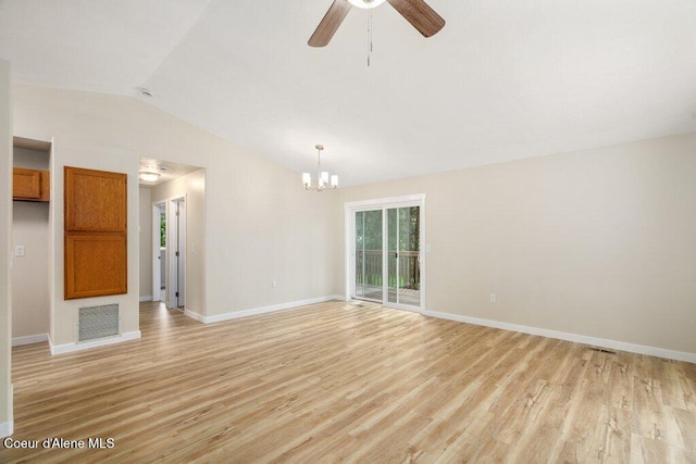 8694 N Clarkview Pl, Hayden Lake, ID 83835 - unfurnished living room with lofted ceiling, light wood finished floors, a chandelier, baseboards, and a ceiling fan