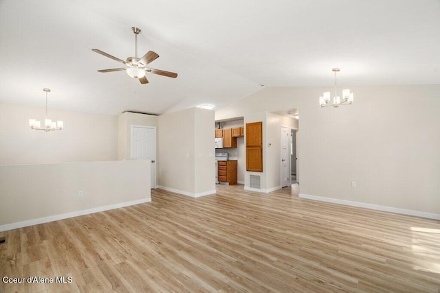 8694 N Clarkview Pl, Hayden Lake, ID 83835 - unfurnished living room with a chandelier, a ceiling fan, lofted ceiling, baseboards, and light wood-style flooring