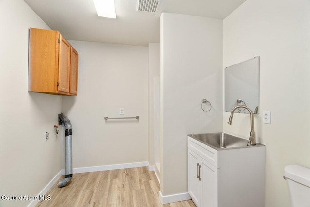 8694 N Clarkview Pl, Hayden Lake, ID 83835 - washroom with a sink, light wood-type flooring, and baseboards