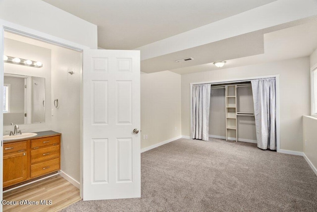 8694 N Clarkview Pl, Hayden Lake, ID 83835 - unfurnished bedroom featuring a sink, a closet, light carpet, and baseboards
