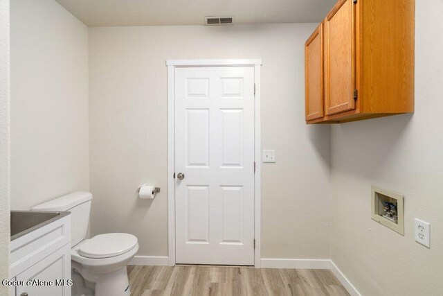 8694 N Clarkview Pl, Hayden Lake, ID 83835 - washroom featuring light wood-style flooring, baseboards, and washer hookup