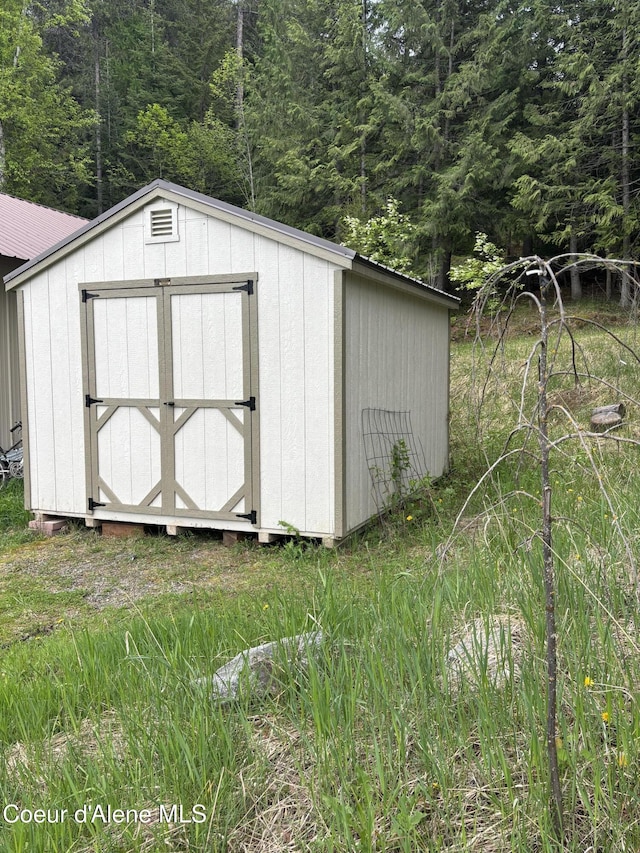 view of shed featuring a forest view