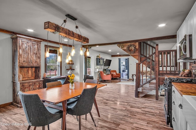 dining room featuring stairway, light wood-style flooring, baseboards, and recessed lighting