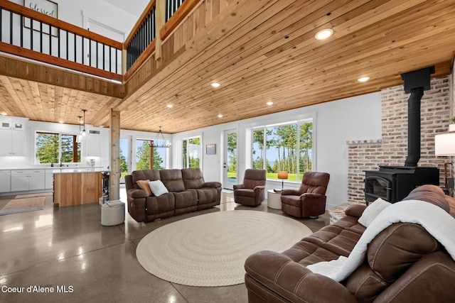 3298 W Coon Creek Rd, Plummer, ID 83851 - living area with a wood stove, recessed lighting, concrete flooring, and wooden ceiling