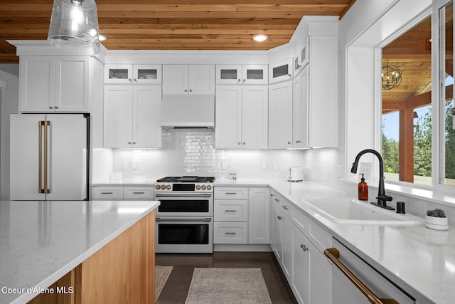 3298 W Coon Creek Rd, Plummer, ID 83851 - kitchen featuring wood ceiling, high quality appliances, custom exhaust hood, a sink, and light stone countertops