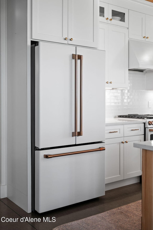 3298 W Coon Creek Rd, Plummer, ID 83851 - kitchen with high end fridge, custom range hood, white cabinets, decorative backsplash, and light countertops