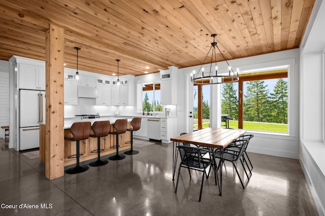 3298 W Coon Creek Rd, Plummer, ID 83851 - dining area with wooden ceiling, a chandelier, baseboards, and finished concrete floors