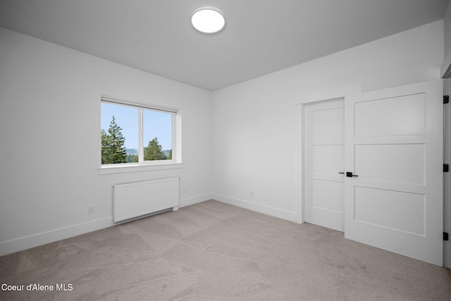 3298 W Coon Creek Rd, Plummer, ID 83851 - carpeted spare room featuring radiator and baseboards