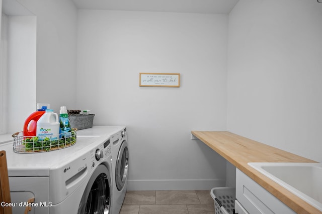 3298 W Coon Creek Rd, Plummer, ID 83851 - washroom featuring washer and dryer, baseboards, and light tile patterned floors
