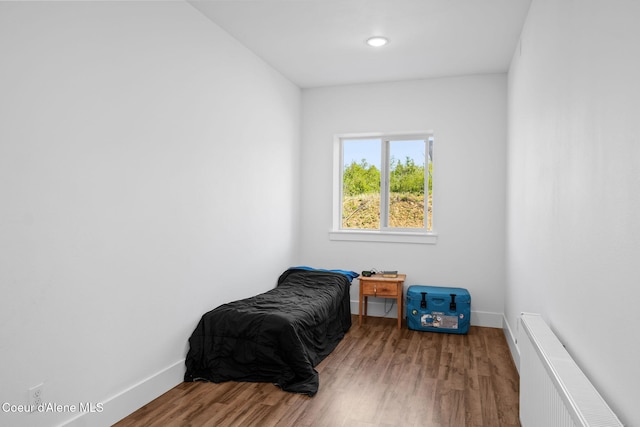 3298 W Coon Creek Rd, Plummer, ID 83851 - bedroom featuring radiator, wood finished floors, and baseboards