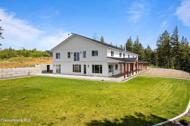 3298 W Coon Creek Rd, Plummer, ID 83851 - back of property featuring board and batten siding, a patio, and a lawn