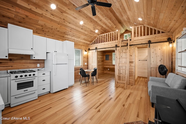 3298 W Coon Creek Rd, Plummer, ID 83851 - kitchen with white appliances, a barn door, wood walls, under cabinet range hood, and wooden ceiling