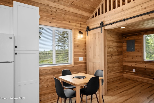 3298 W Coon Creek Rd, Plummer, ID 83851 - dining area with a barn door, wood walls, wooden ceiling, lofted ceiling, and electric panel