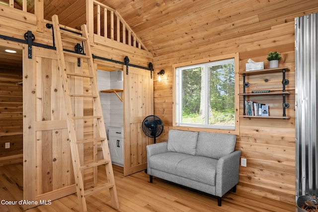 3298 W Coon Creek Rd, Plummer, ID 83851 - living area with a barn door, vaulted ceiling, wood walls, light wood-style floors, and wood ceiling