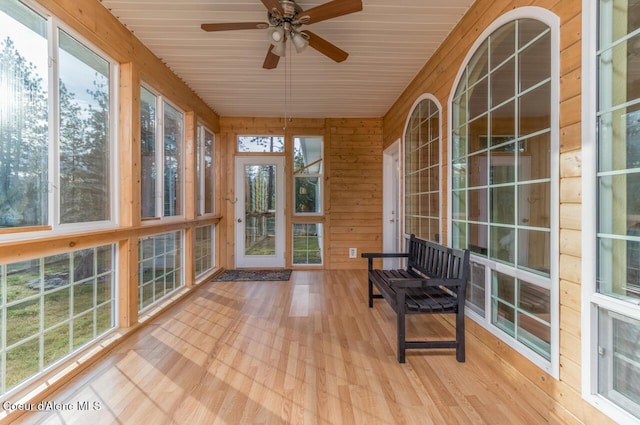 684 Chute Canyon Way, Bonners Ferry, ID 83805 - unfurnished sunroom featuring wood walls, plenty of natural light, wood finished floors, ceiling fan, and wood ceiling