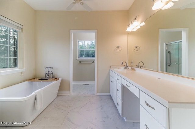 684 Chute Canyon Way, Bonners Ferry, ID 83805 - full bathroom with ceiling fan, marble finish flooring, vanity, a freestanding tub, and a shower with shower door