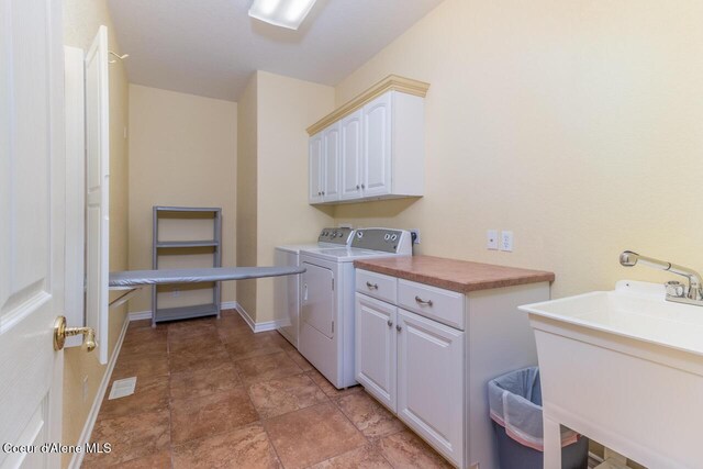 684 Chute Canyon Way, Bonners Ferry, ID 83805 - laundry area featuring cabinet space, washing machine and clothes dryer, and baseboards